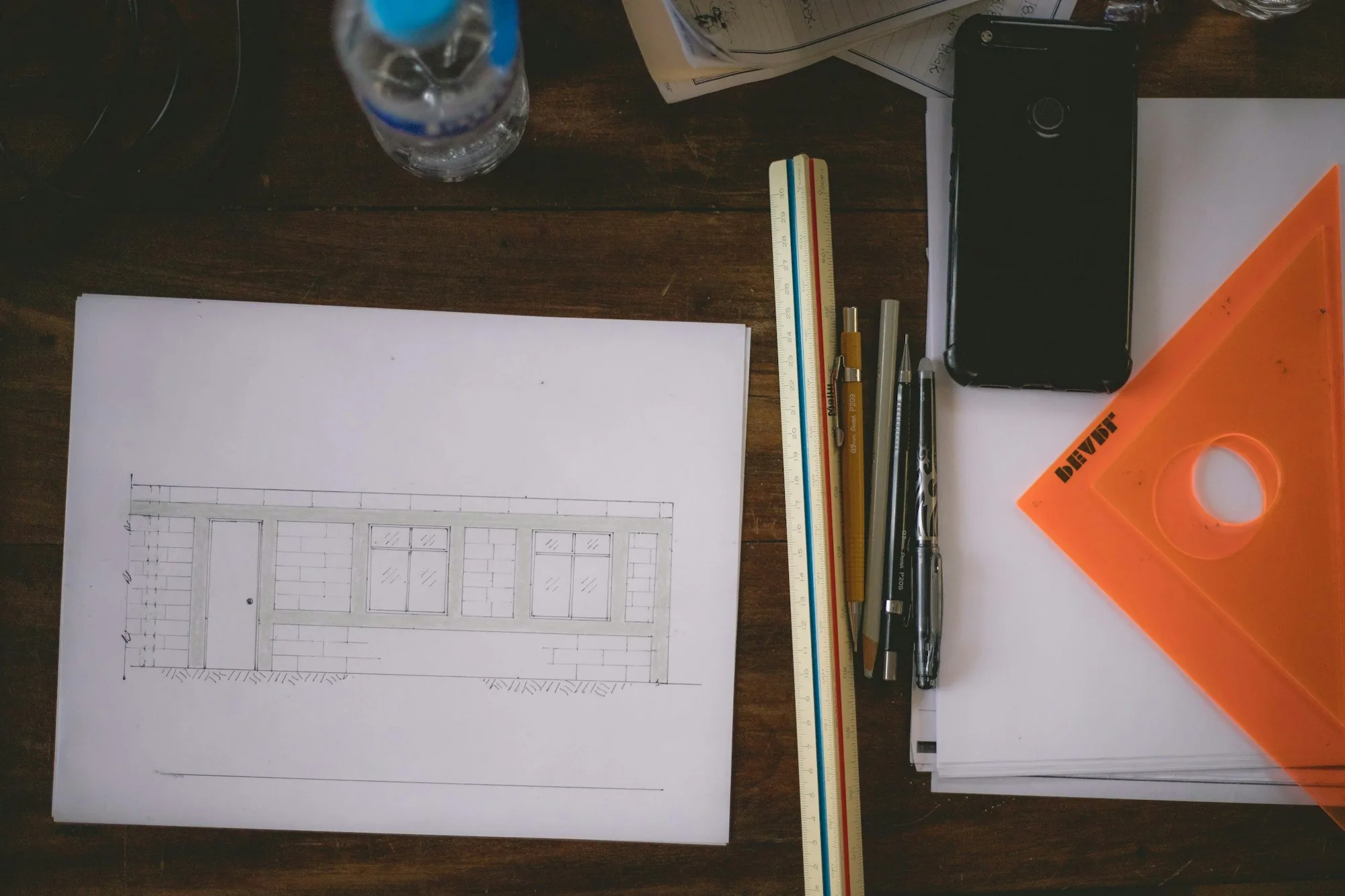 A blueprint and ruler on a drafting table