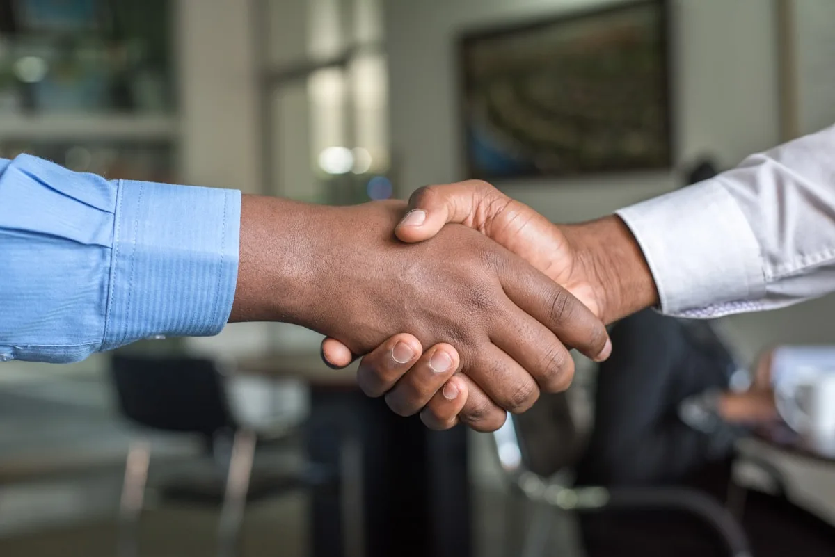 Trade partnership handshake on site