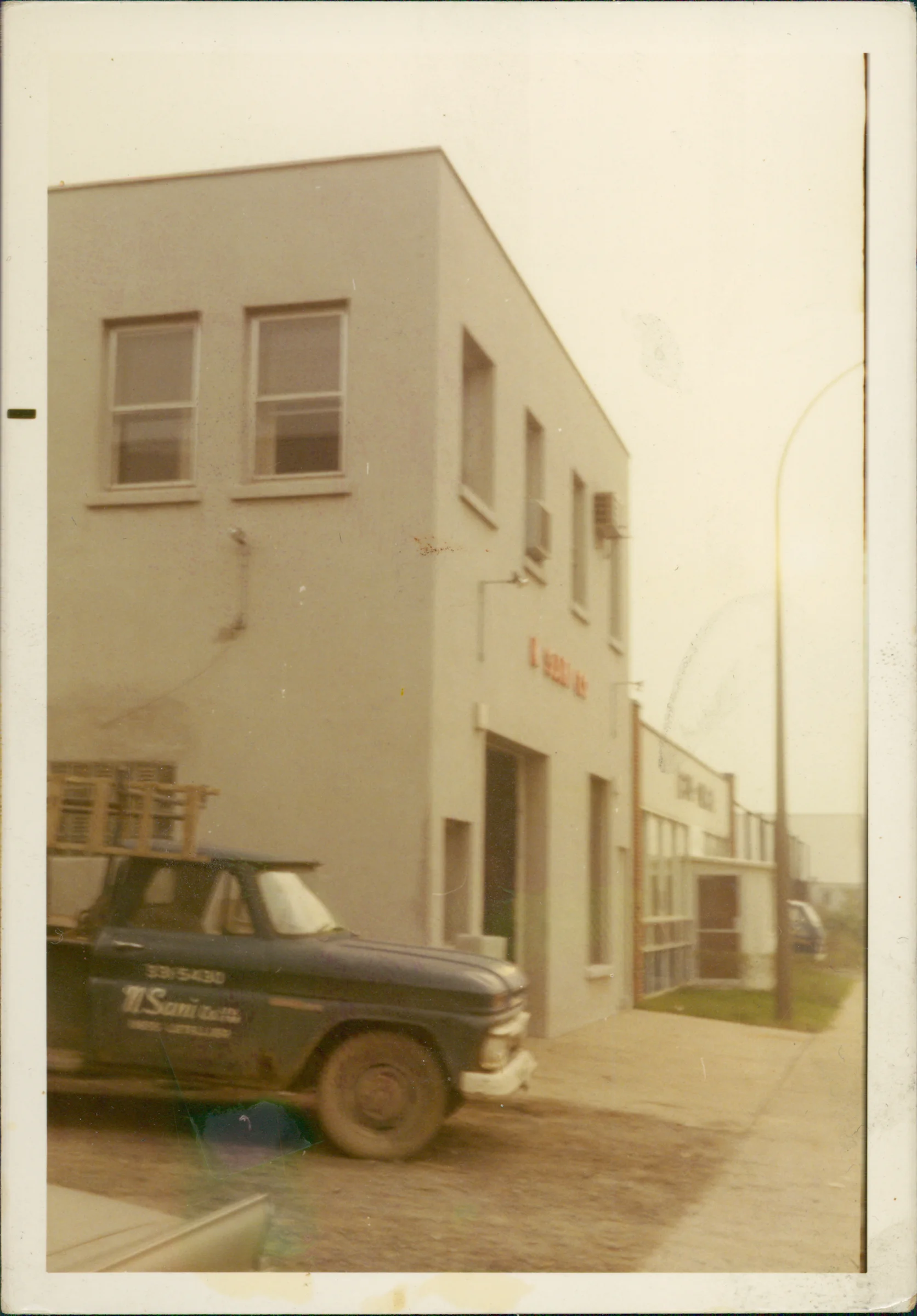 Vintage N.Sani truck in front of the original Montreal office, 1957-era